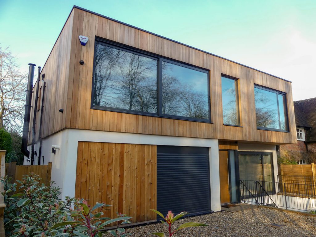 brown home with black garage door on